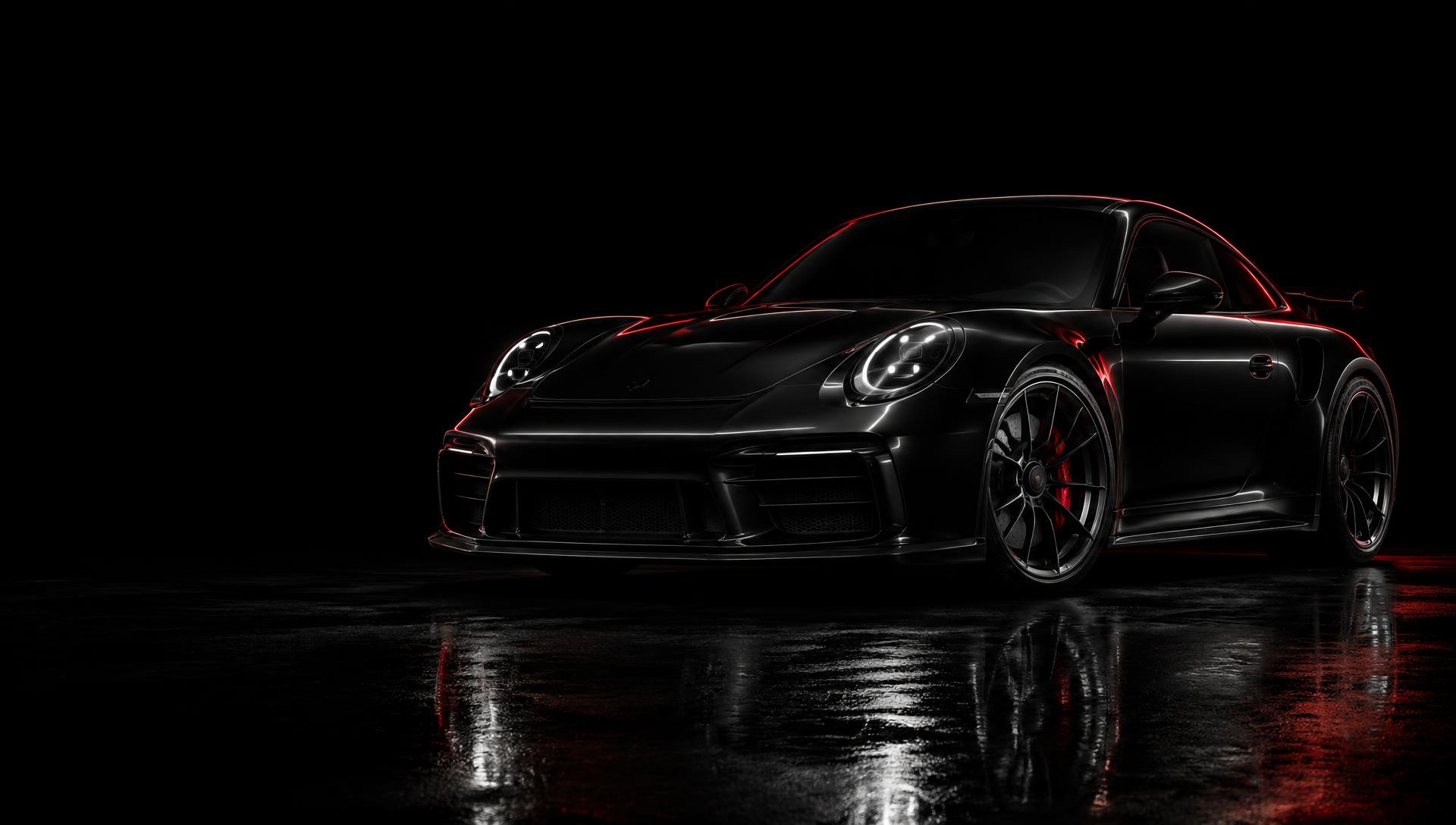 Coupé sportiva scura in officina con illuminazione radente